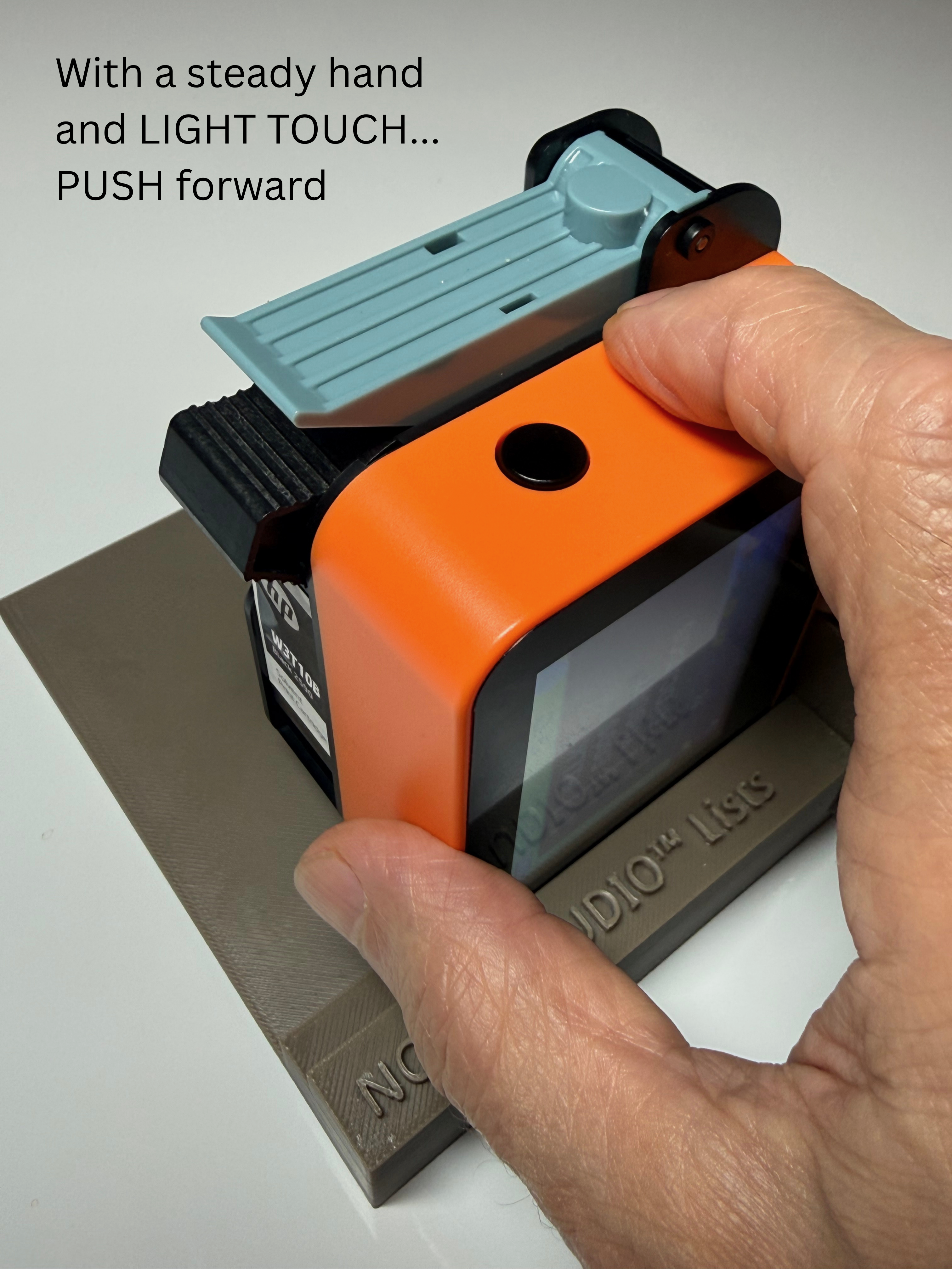 Use a steady hand and LIGHT TOUCH to PUSH the printer forward. You will hear another 'beep' when the print is complete.