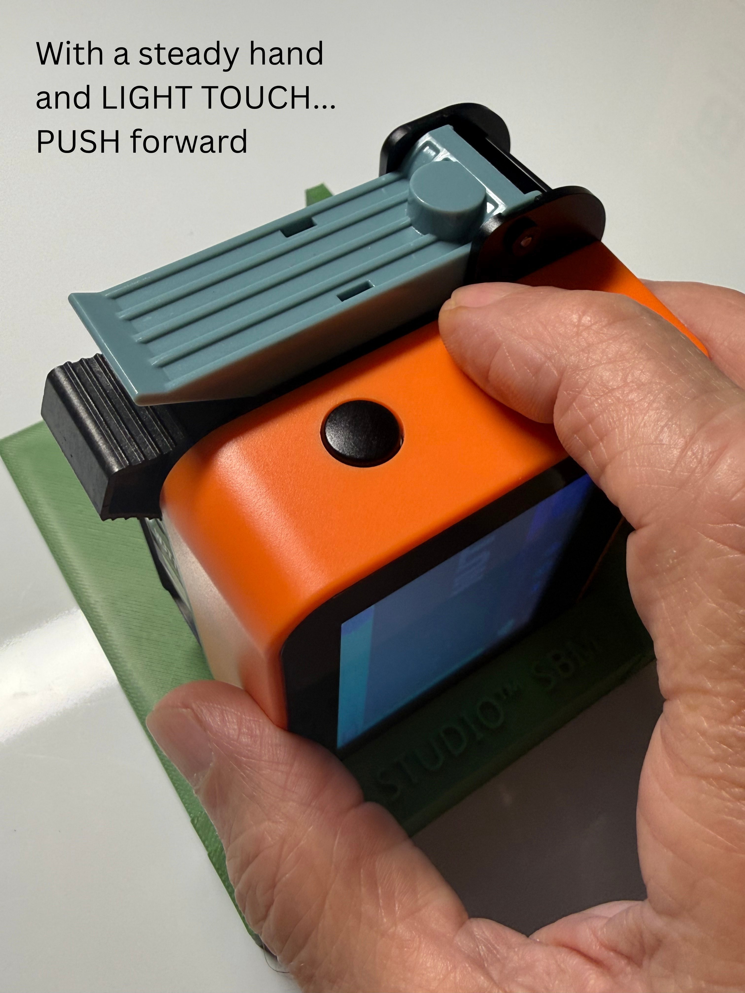 Use a steady hand and LIGHT TOUCH to PUSH the printer forward. You will hear another 'beep' when the print is complete.